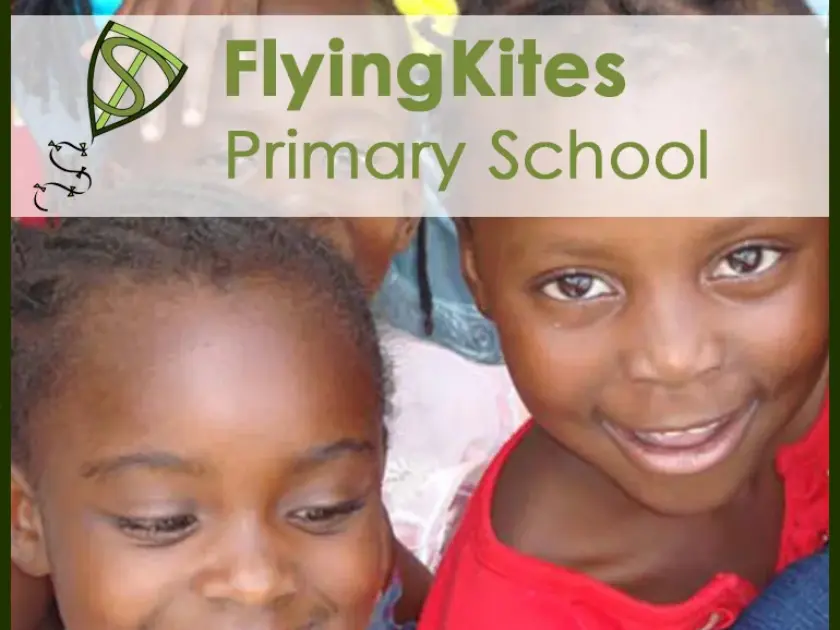 Two smiling children close together, one wearing a red top, with a translucent banner reading 'FlyingKites Primary School' at